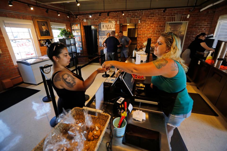 Kristen Sharp serves a customer at the newly opened Mirasol's Cafe Express at Pier 3 in New Bedford.