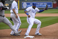 Kansas City Royals first baseman Carlos Santana (41) beats Cleveland Guardians' Bobby Bradley, left, to first base for the out during the fourth inning of a baseball game, Thursday, April 7, 2022 in Kansas City, Mo. (AP Photo/Reed Hoffmann)