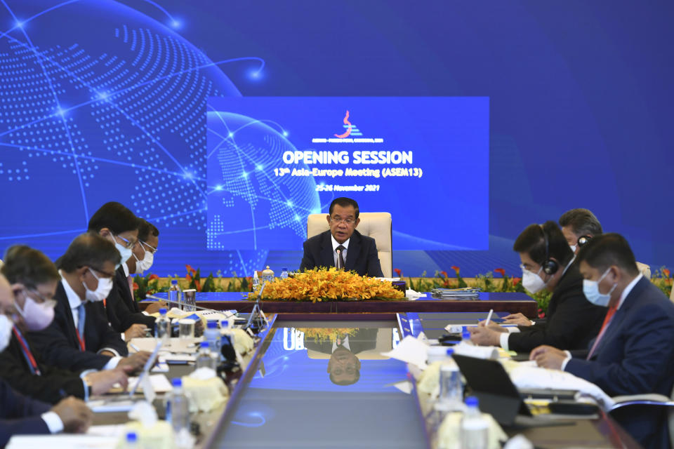 In this photo provided by An Khoun Sam Aun/Ministry of Information of Cambodia, Cambodian Prime Minister Hun Sen, center, attends during an online opening session of the Asia-Europe Meeting (ASEM) in Phnom Penh, Cambodia, Thursday, Nov. 25, 2021. Hun Sen on Thursday welcomed leaders of Asian and European nations to the 13th biennial Asia-Europe Meeting, held virtually and postponed from last year due to the coronavirus pandemic. (An Khoun Sam Aun/Ministry of Information of Cambodia via AP)