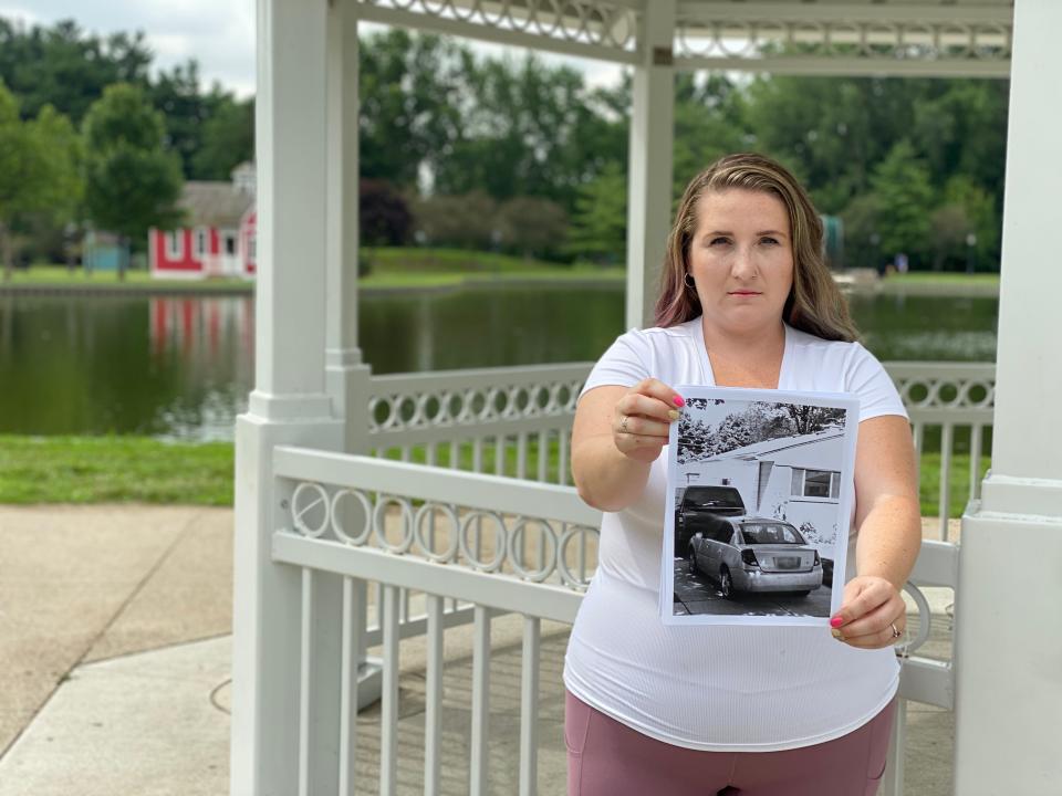 Stephanie Wilson holds a photo of her vehicle, which police seized in 2019.