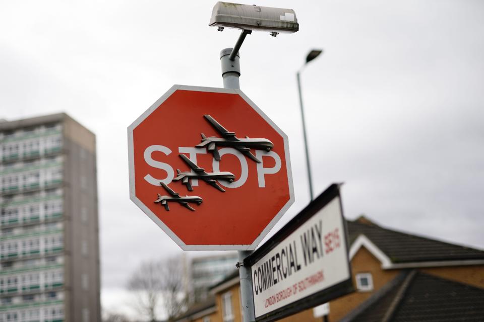Banksy has unveiled a new piece of art work at the intersection of Southampton Way and Commercial Way in Peckham, south east London, which shows three planes perched on a stop sign. Picture date: Friday December 22, 2023.