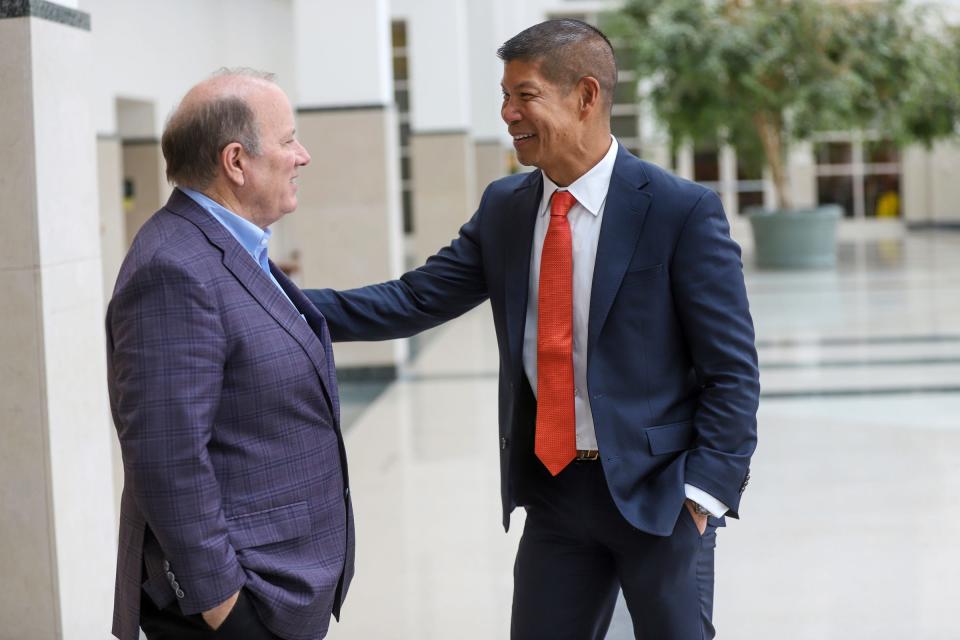 CURE's CEO Eric Poe, right, was an advisor to Detroit Mayor Mike Duggan back in 2015, when the mayor was researching ways to reduce Detroit's highest-in-the-nation auto insurance rates and are seen together at the ribbon-cutting for CURE's new Detroit offices on Wednesday, Aug. 30, 2023.