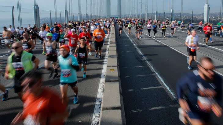thousands run across a bridge in new york city