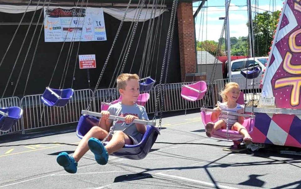 Cooper and Nashlynn Deyton enjoy the swings on the opening day of the North Carolina Apple Festival on Sept. 1. After the ride ended, they both went to their grandparents and said, "Thank you so much for bringing us here."