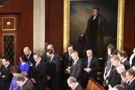 Members of Congress bow their heads in prayer as they gather to elect the speaker on the first day of their new session at the U.S. Capitol in Washington January 6, 2015. REUTERS/Jonathan Ernst