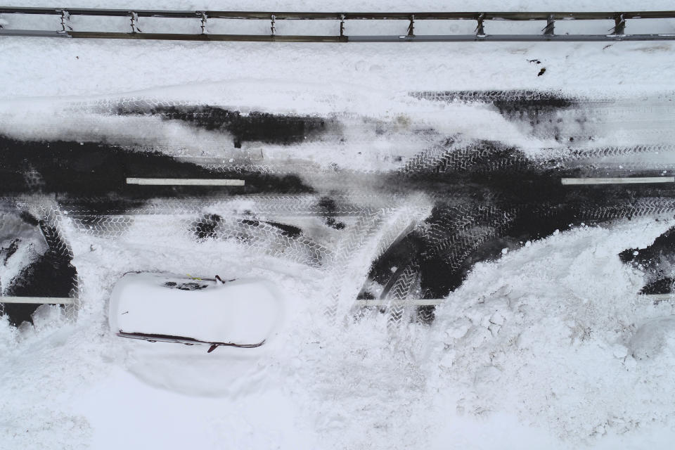 An abandoned vehicle remains on the Scajaquada Expressway in Buffalo, N.Y. several days after it was abandoned during the blizzard Tuesday, Dec. 27, 2022. A driving ban remains in effect in the city as cleanup continues. (Derek Gee /The Buffalo News via AP)