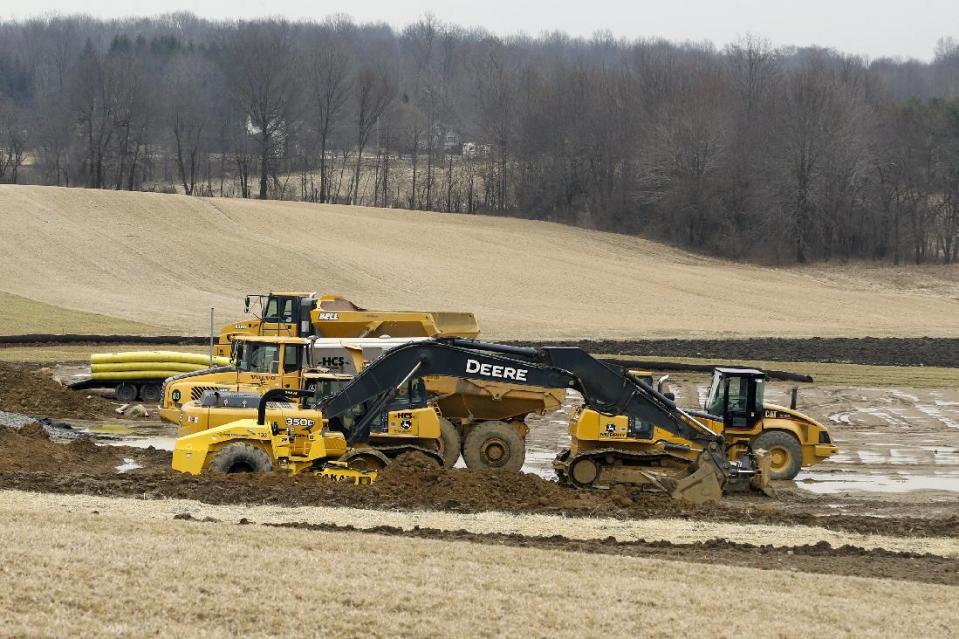 In this March 20, 2014 photo, equipment is parked at a gas well drilling site in Pulaski, Pa. The gas drilling company Hilcorp that is working the well has asked state officials to invoke a 1961 law in the rural area and allow Utica Shale well bores under the property of four landowners who haven’t signed leases. (AP Photo/Keith Srakocic)