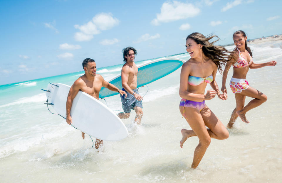 a group of people running out of the ocean