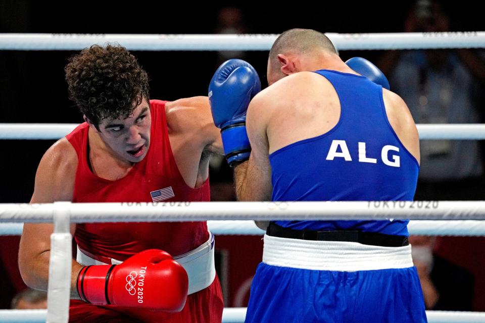 Richard Torrez Jr., left, takes on Chouaib Bouloudinats of Algeria in a match at the Tokyo Olympics.