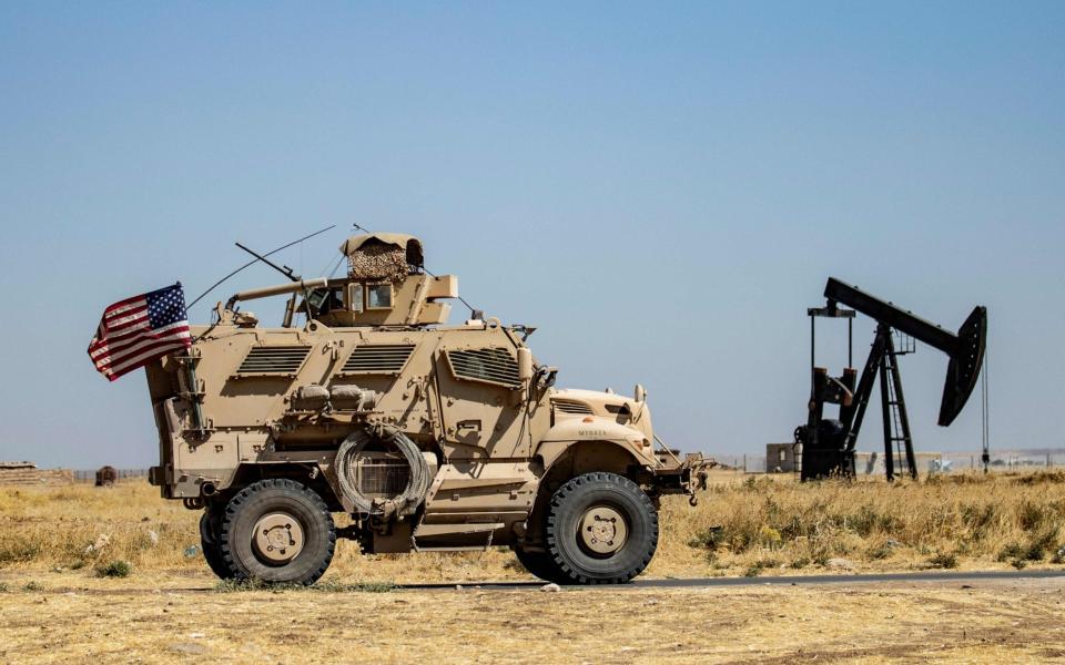 A US military vehicle patrols near the Rumaylan (Rmeilan) oil fields in Syria's Kurdish-controlled northeastern Hasakeh province - AFP