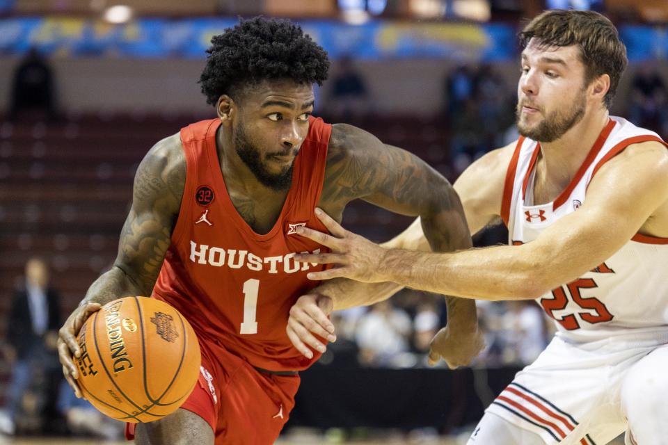 Houston’s Jamal Shead (1) dribbles against the defense of Utah’s Rollie Worster (25) in the first half of an NCAA college basketball game during the Charleston Classic in Charleston, S.C., Friday, Nov. 17, 2023. | Mic Smith, Associated Press