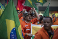 Oil workers march during a protest against layoffs at state oil company Petrobras in Rio de Janeiro, Brazil, Tuesday, Feb. 18, 2020. Brazilian oil workers and oil giant Petrobras were locked in a power struggle Tuesday over the company's privatization plans, with the union saying thousands of employees are on an indefinite strike. (AP Photo/Silvia Izquierdo)