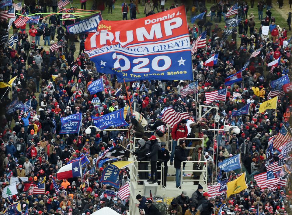 Supporters of US President Donald Trump take over stands set up for the presidential inauguration as they protest at the US Capitol in Washington, DC, January 6, 2021.  (Olivier Douliery/AFP via Getty Images)