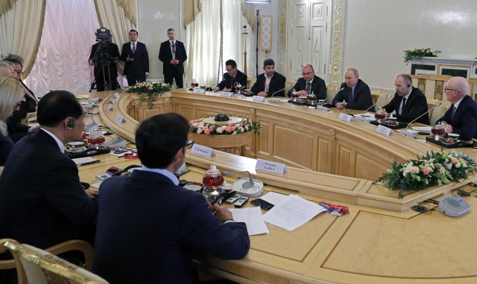 Russian President Vladimir Putin, second right, speaks during a meeting with heads of world's leading news agencies at the St. Petersburg International Economic Forum in St. Petersburg, Russia, Thursday, June 6, 2019. (Yuri Kochetkov/Pool Photo via AP)