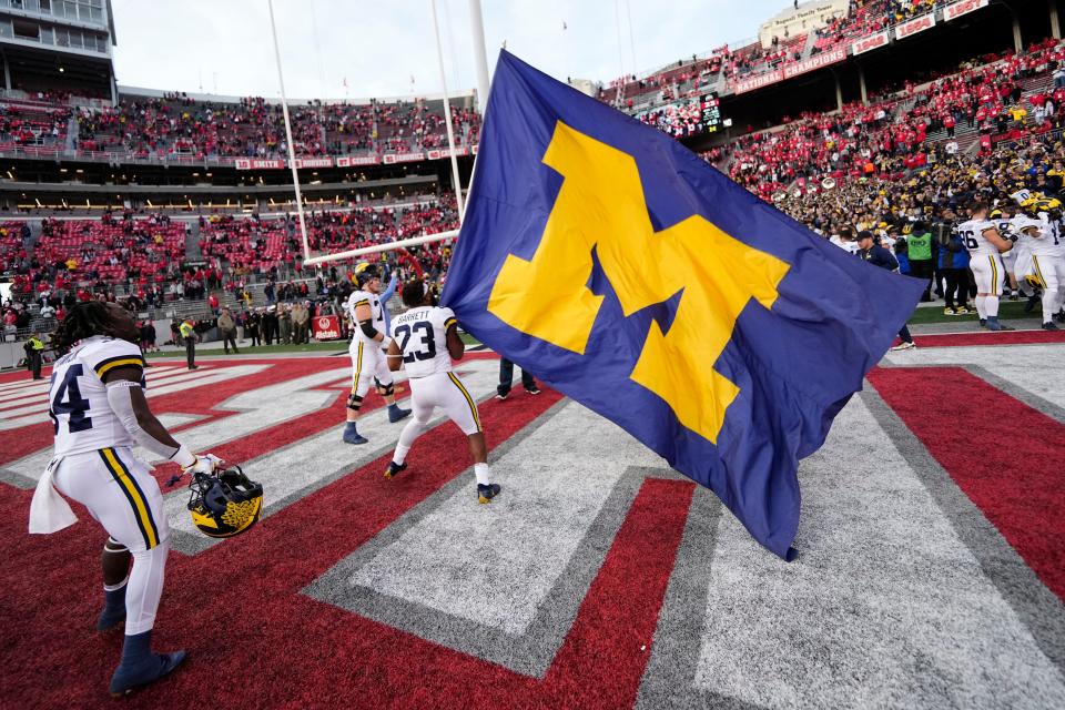 Nov 26, 2022; Columbus, Ohio, USA;  Michigan Wolverines linebacker Michael Barrett (23) waves the Michigan flag following their 45-23 win over the Ohio State Buckeyes in the NCAA football game at Ohio Stadium. Mandatory Credit: Adam Cairns-The Columbus Dispatch