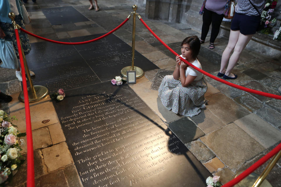 A young girl looks at the grave stone of Jane Austen at Winchester Cathedral, where the Governor of the Bank of England Mark Carney will unveil the new &#xa3;10 note featuring the author, which marks the 200th anniversary of her death. (Photo by Steve Parsons/PA Images via Getty Images)