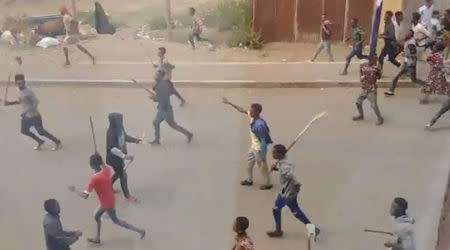 Demonstrators walk along a street in Asella, Oromiya Province, Ethiopia February 13, 2018, in this still image taken from a social media video. Mandatory Credit. TWITTER/@WAGUWAGU91 via REUTERS