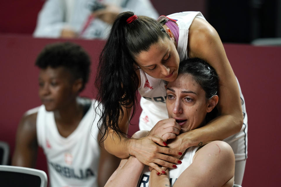 Serbia's Jelena Brooks gets a hug from teammate Sasa Cado after the women's basketball bronze medal game against France at the 2020 Summer Olympics, Saturday, Aug. 7, 2021, in Saitama, Japan. (AP Photo/Charlie Neibergall)