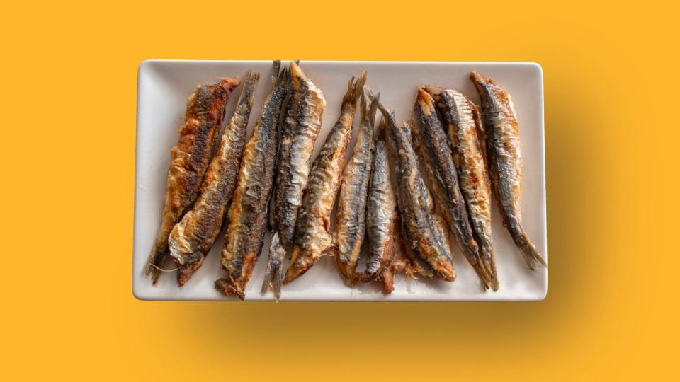 Anchovies sitting on china plate