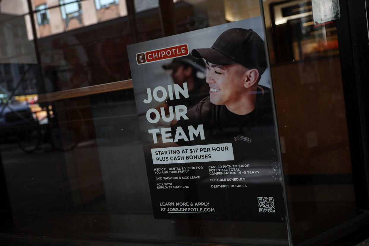 A sign for hire is posted on the window of a Chipolte Restaurant in New York City, U.S., April 29, 2022.  REUTERS/Shannon Stapleton