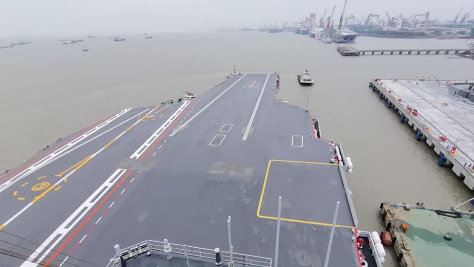 A tugboat tows China's third aircraft carrier, the Fujian, away from a dock in east China's Shanghai on May 1, 2024. - Li Tang/Xinhua