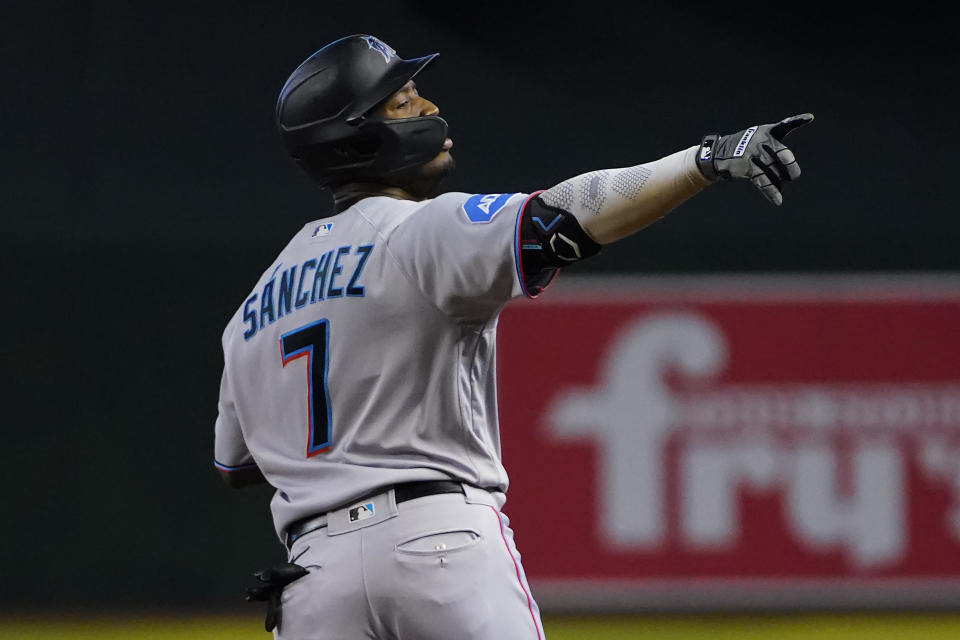 Miami Marlins' Jesus Sanchez points to his dugout after hitting a three run home run against the Arizona Diamondbacks during the fourth inning of a baseball game, Wednesday, May 10, 2023, in Phoenix. (AP Photo/Matt York)