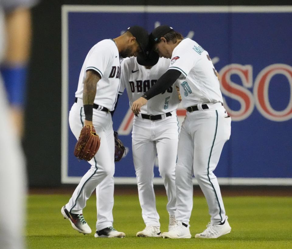 May 24, 2022; Phoenix, Ariz., U.S.; Arizona Diamondbacks left fielder David Peralta (6), center fielder Alek Thomas (5) and right fielder Jake McCarthy (30) celebrate their 8-6 victory against the Kansas City Royals at Chase Field.