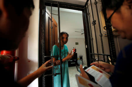 Town council volunteers distribute flyers and insect repellents to residents at a new Zika cluster area in Singapore