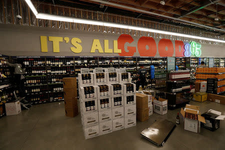 Employees arrange wine at a 365 by Whole Foods Market grocery store is pictured ahead of its opening day in Los Angeles, U.S., May 24, 2016. REUTERS/Mario Anzuoni