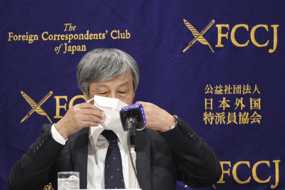 Dr. Naoto Ueyama, chairman of Japan Doctors Union, takes off his face mask to speak during a press conference Thursday, May 27, 2021, in Tokyo. Dr. Ueyama warned Thursday that holding the one-year-delayed Tokyo Olympics in two months could lead to the spread of mutant variants of the coronavirus. (AP Photo/Eugene Hoshiko)