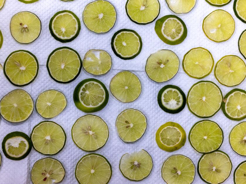 Sliced limes sit out to dry before being used to decorate floats.