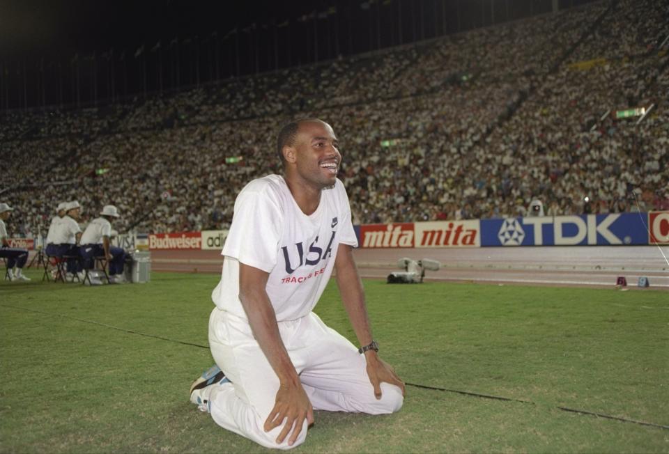 1991:  Mike Powell of the United States kneels in triumph after competing in the 8.95 meter long jump during the World Championship Games in Tokyo, Japan. Powell set the world record winning this event. Mandatory Credit: Mike Powell  /Allsport