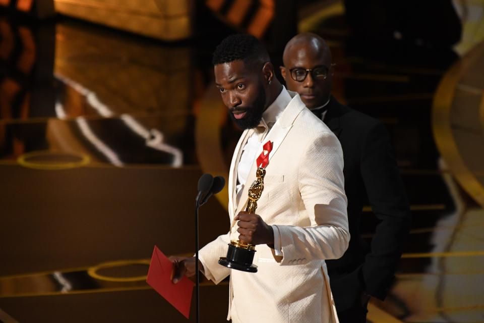 Tarell Alvin McCraney, left, and Barry Jenkins accept the award for best adapted screenplay for 'Moonlight" during the 89th Academy Awards in Los Angeles in February.