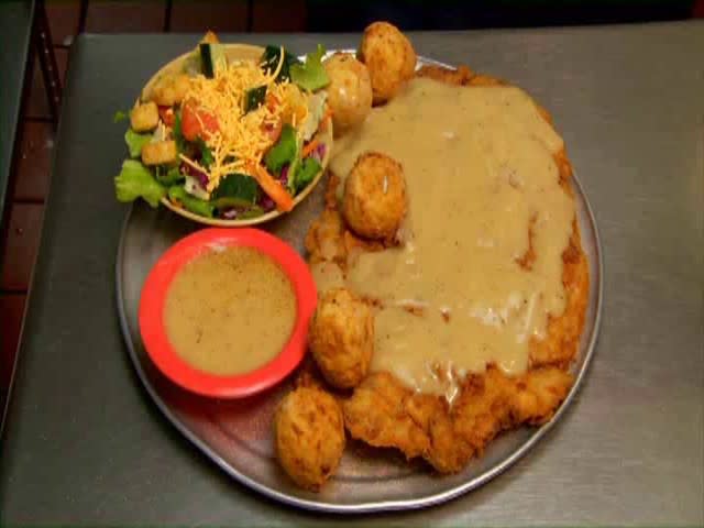 <b>Texas: The Saddle Blanket</b> This huge chicken-fried-steak is topped with "Texas River Bottom Gravy" at the Hickory Hollow Restaurant.<br> <br> (Image courtesy Hickory Hollow Restaurant)