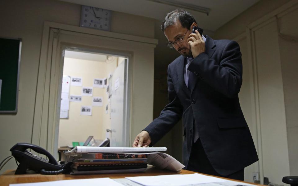 In this Monday, Feb. 3, 2014 photo, Mujahid Kakar, Tolo anchor and mediator of the upcoming debate talks on the phone at his office in Kabul, Afghanistan. The proliferation of Afghan media in the past 12 years is one of the most visible bright spots of the fraught project to foster a stable democracy. (AP Photo/Massoud Hossaini)