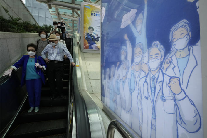 A poster hoping to overcome the COVID-19 crisis is displayed at a train station in Seoul, South Korea, Tuesday, July 6, 2021. (AP Photo/Ahn Young-joon)