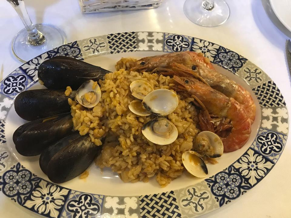 This Oct. 14, 2019 photo shows seafood paella at a restaurant in Barcelona, Spain. While tapas let you sample delicacies like cod croquettes and calamari, you don’t have to miss out on the paella that’s usually for two or more: Chefs would make a solo serving of the rice dish. (Courtney Bonnell via AP)