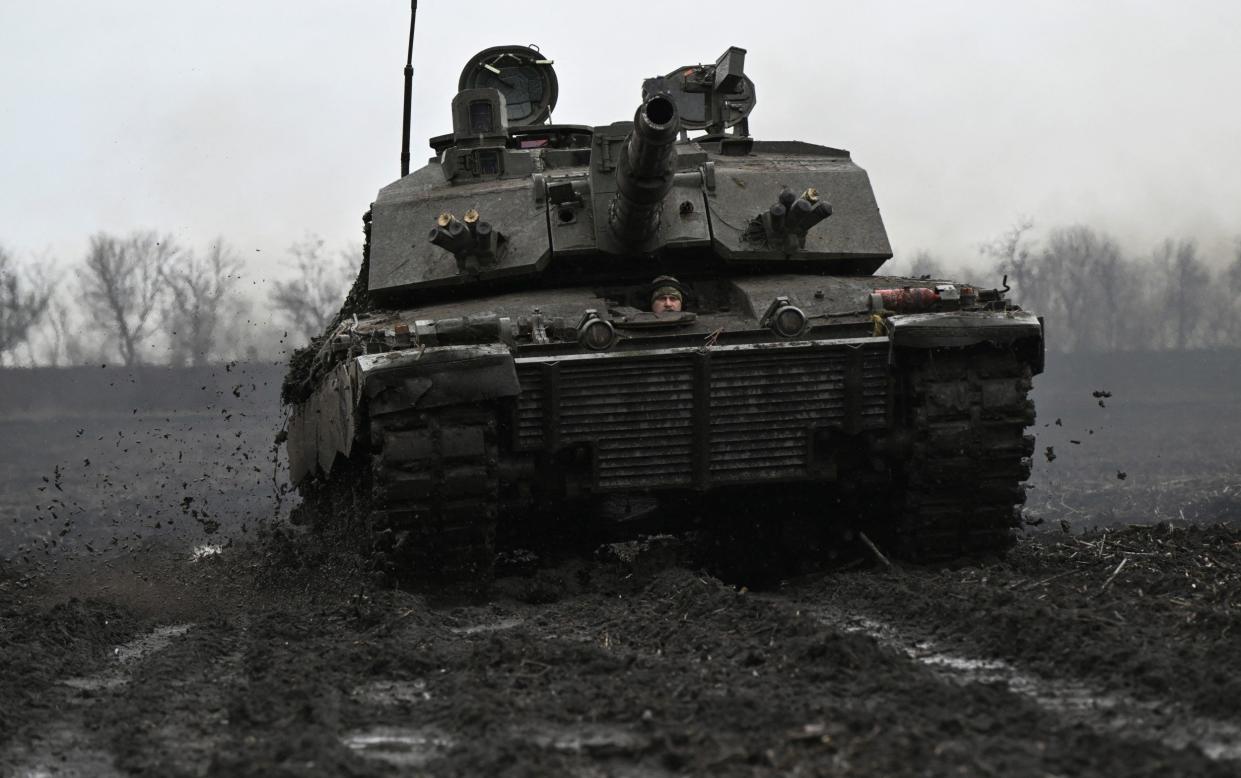 A Ukrainian serviceman of the 82nd Separate Air Assault Brigade prepares for combat in a British Challenger 2