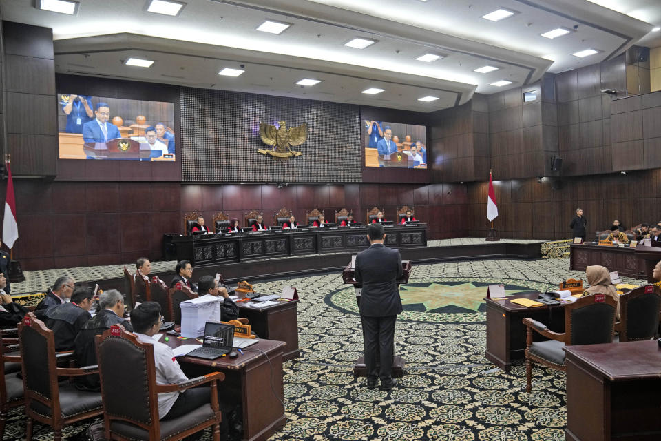 Losing presidential candidate Anies Baswedan, center, speaks as judges listen during the first hearing of his legal challenge to the Feb. 14 presidential election alleging widespread fraud, at the Constitutional Court in Jakarta, Indonesia, Wednesday, March 27, 2024. Defense Minister Prabowo Subianto, who chose the son of the popular outgoing President Joko Widodo as his running mate, won the election by 58.6% of the votes, according to final results released by the Election Commission. (AP Photo/Dita Alangkara)