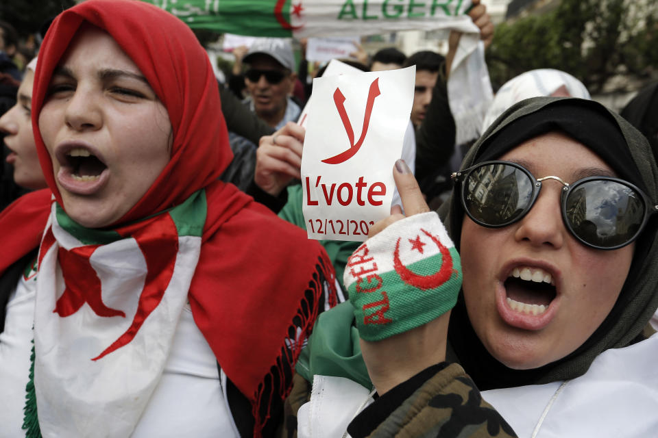 FILE - An Algerian student holds a poster reading "No to the vote on Dec.12" during a protest in Algiers, Tuesday, Jan.10, 2019. President Abdelmadjid Tebboune's surprise decision to schedule elections earlier than expected in Algeria is prompting suspicion and appears to be awakening discouraged political parties from a deep lethargy. (AP Photo/Toufik Doudou, File)