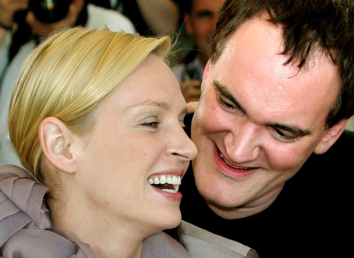 Quentin Tarantino laughs with Uma Thurman as they promote their film ‘Kill Bill Vol 2’ at the 57th Cannes on 16 May 2004 (Reuters)