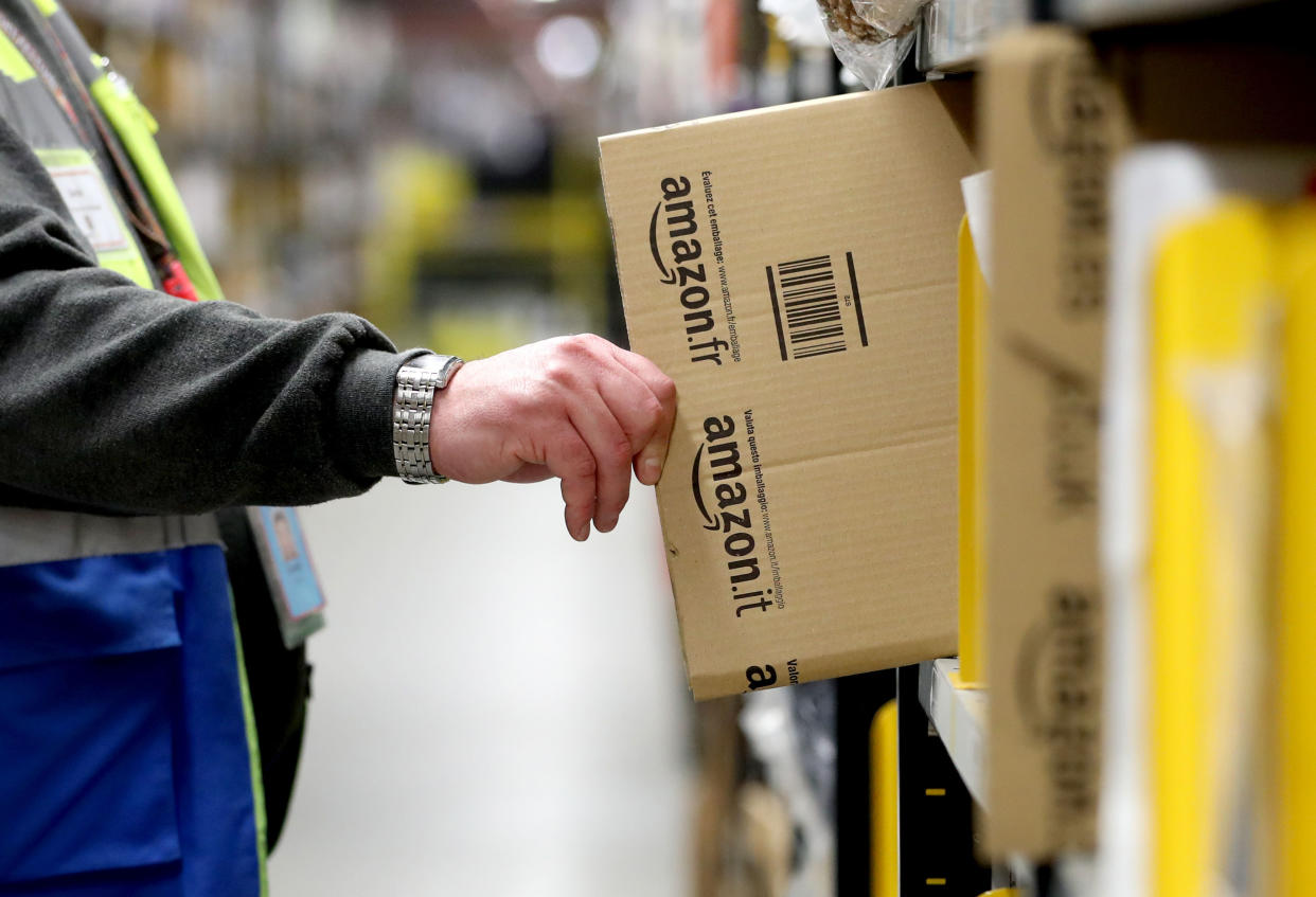 Staff make their way around the aisles collecting items before sending them to the on-site dispatch hall to be packaged inside one of Britain's largest Amazon warehouses in Dunfermline, Fife, as the online shopping giant gears up for the Christmas rush and the forthcoming Black Friday sales. (Photo by Jane Barlow/PA Images via Getty Images)