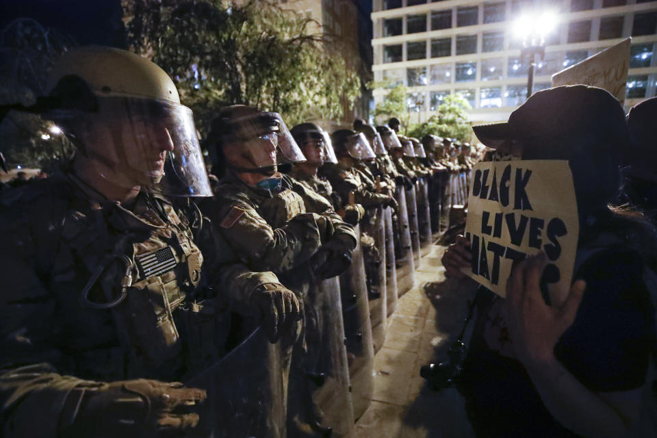 Utah National Guard soldiers line the street as demonstrators gather to protest the death of George Floyd, Wednesday, June 3, 2020, near the White House in Washington. Floyd died after being restrained by Minneapolis police officers. (AP Photo/Alex Brandon)