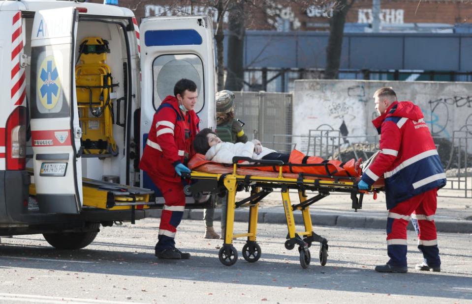 <div class="inline-image__caption"><p>Medical specialists transport a wounded woman to an ambulance after shelling in Kyiv.</p></div> <div class="inline-image__credit">Gleb Garanich/Reuters</div>