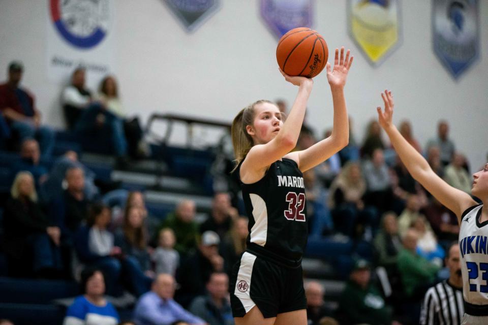 Holland Christian's Jenna VandenBrink takes a shot over the Hopkins defense Wednesday, March 1, 2023, at Hopkins High School. 