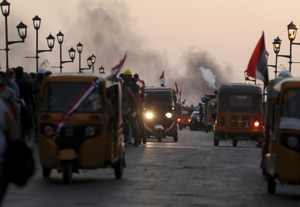 Iraqi security forces fire live ammunition and tear gas while anti-government protests gather near the state-run TV in Baghdad, Iraq, Monday, Nov. 4, 2019. (AP Photo/Hadi Mizban)