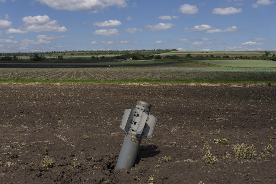 An unexploded Russian rocket lays on a field near Soledar, eastern Ukraine, Monday, June 6, 2022. (AP Photo/Bernat Armangue)