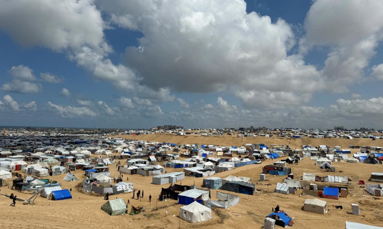 <span>Palestinians taking shelter in a tent camp near the border of Egypt. Earlier in the war, some Palestinians were refused visitor visas to Australia because ‘they did not demonstrate a genuine intention to stay temporarily’.</span><span>Photograph: Mohammed Salem/Reuters</span>