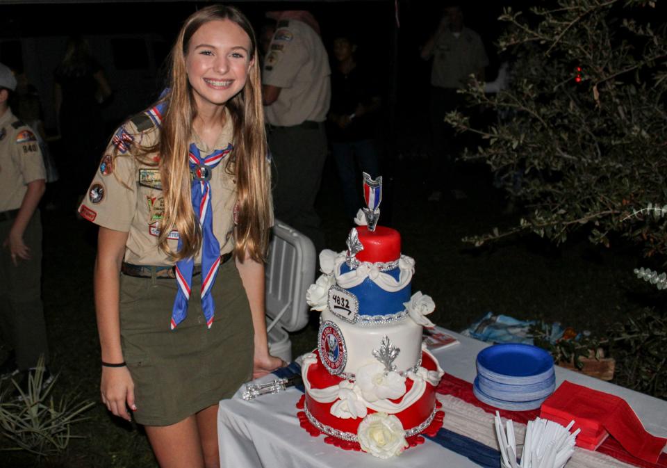 New Eagle Scout Mia Stahl, the first female in Martin County to achieve the rank, poses next to a cake celebrating her achievement, following her Eagle Scout Court of Honor Ceremony on Dec. 10, 2023 at the Jupiter Inlet Lighthouse Outstanding Natural Area.