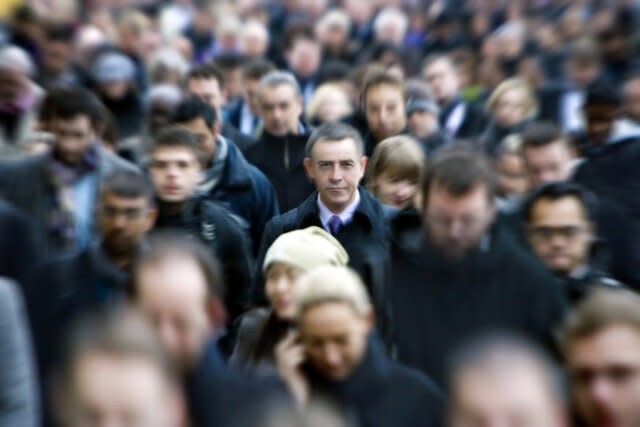 Blurred commuters with one man in focus